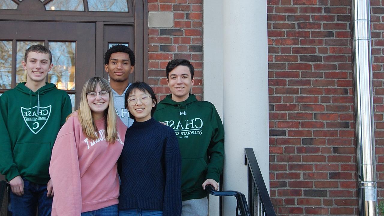 Students of Chase Collegiate smiling on the steps